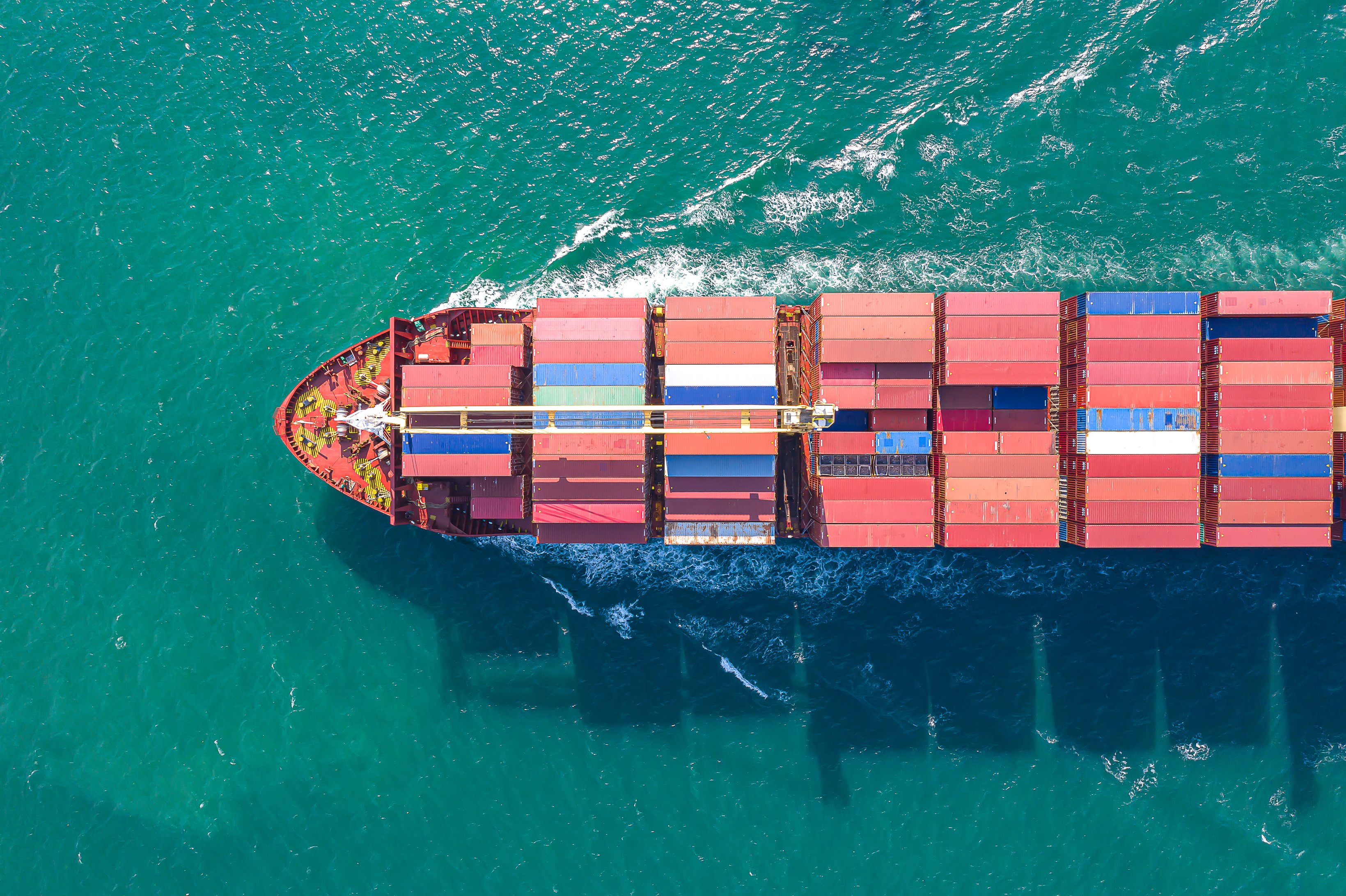 Aerial top view of cargo ship carrying container for import export goods  to customer,concept logistic and supply chain